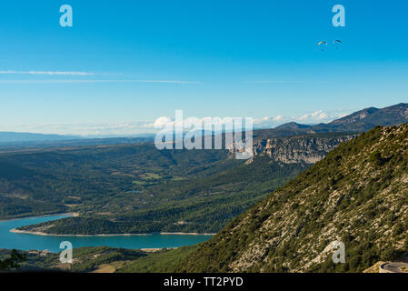 Two paratroopers flying over the  blue Lac de Sainte-Croix lake near Verdon gorges in Provence, France
