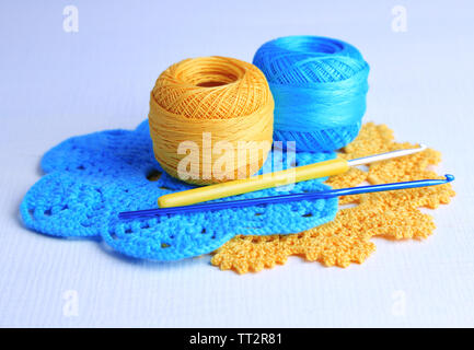 Colorful clews and crochet hooks on light background Stock Photo