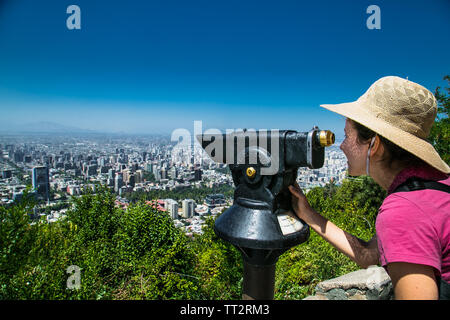 Santiago, Chile - Dec 29, 2018: Beautiful woman with hat looking funicular to Cerro San Cristobal hill in Santiago, Chile Stock Photo