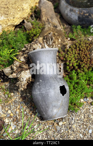 Old retro amphora in garden Stock Photo