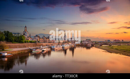 Dresden, Germany. Panoramic cityscape image of Dresden, Germany with reflection of the city in the Elbe river, during sunset.