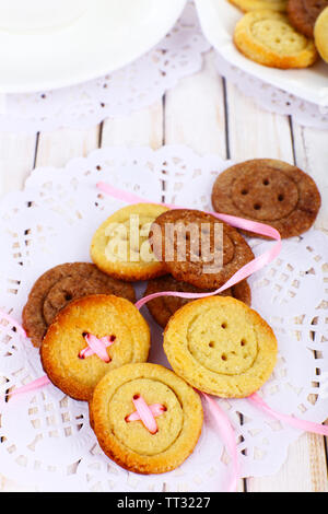 Sugar cookies in shape of buttons on table Stock Photo