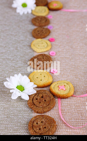 Sugar cookies in shape of buttons on table Stock Photo