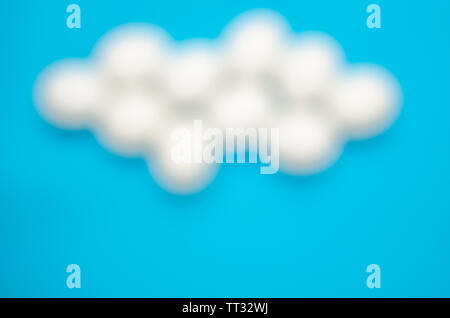 White chicken eggs the shape of clouds on bright blue background.Sky. Stock Photo