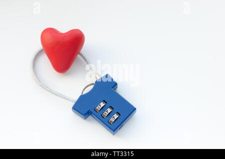 Red heart on a blue combination lock on white background Stock Photo