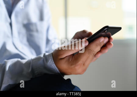 Close-up Young man with smartphone work and talking on the phone Stock Photo