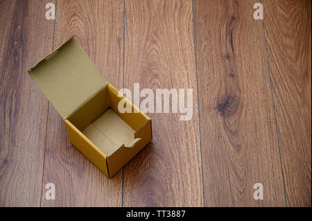 box empty open cardboard box on wooden surface with empty space top Flat lay Stock Photo