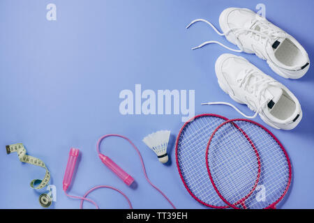 Sport equipment. Shuttlecock and badminton racket, skipping rope, sneakers  and measuring tape on purple background. Fitness, sport and healthy lifesty  Stock Photo - Alamy