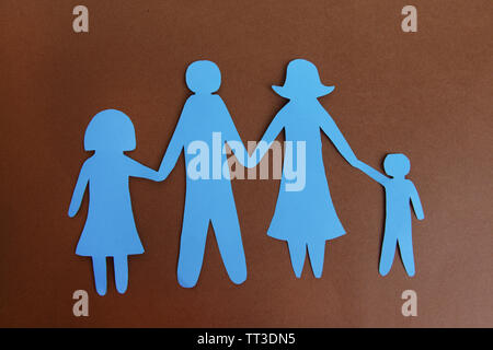 Paper family on brown background Stock Photo