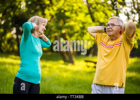 Senior couple is exercising in park. Stock Photo