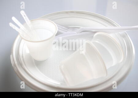 Group of plates with disposable plastic glasses and forks. Stock Photo