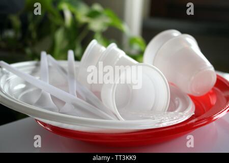 Group of plates with disposable plastic glasses and forks Stock Photo