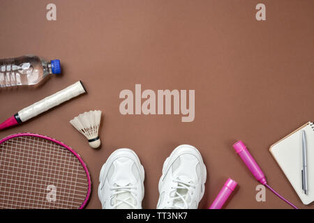 Sport equipment. Shuttlecock and badminton racket, skipping rope, sneakers  and measuring tape on purple background. Fitness, sport and healthy lifesty  Stock Photo - Alamy