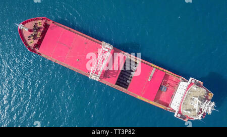 Red General cargo ship at sea - Aerial image Stock Photo