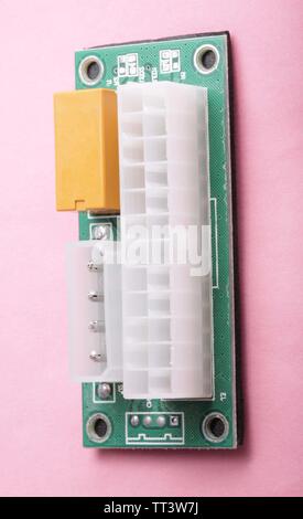 Mining ATX 24Pin Dual PSU Power Supply Sync Starter on pink background Stock Photo