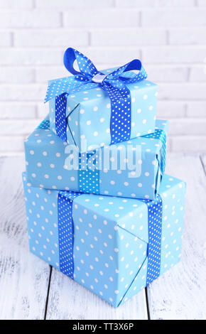 Beautiful gifts on table on brick wall background Stock Photo Alamy