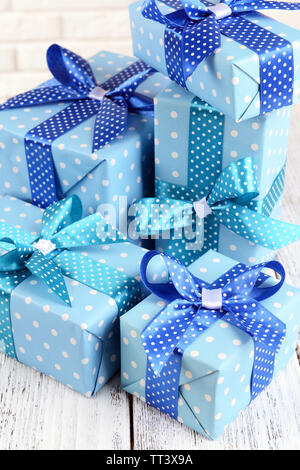 Beautiful gifts on table on brick wall background Stock Photo Alamy