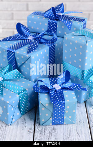 Beautiful gifts on table on brick wall background Stock Photo Alamy