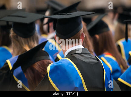 Lincoln, UK, September 10, 2014. Students sit in a row at their university graduation ceremony