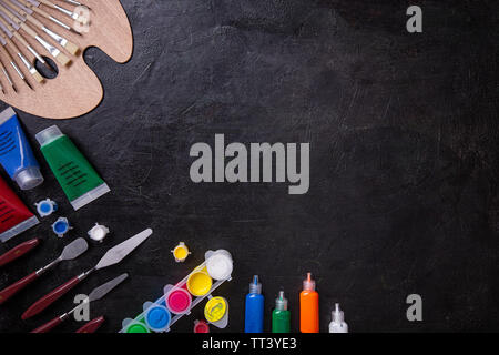 Art of Painting. Painting set: brushes, paints, watercolor, acrylic paint on a black background Stock Photo