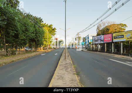 Campo Grande - MS, Brazil - June 10, 2019: Transit on a ordinary day at Ceara avenue close to the Uniderp college. Photo in the middle of the avenue ( Stock Photo