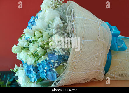 White rose and blue hydrangea bouquet on the table Stock Photo