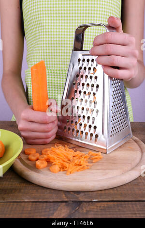 chef shredding carrots with grater in kitchen Stock Photo - Alamy