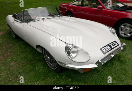 Three-quarter front view of a White,  1970, Jaguar E-Type, on display at the Quay Green Classic Car Meet, part of  the 2018 Sandwich Festival, Kent Stock Photo