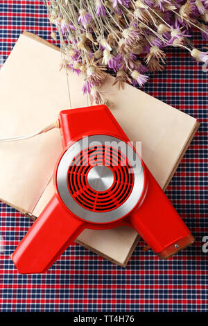 Retro hairdryer and book on table, close up Stock Photo