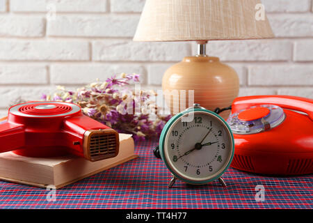 Retro things on table-hairdryer, clock, phone, book Stock Photo