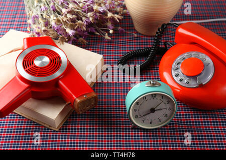 Retro things on table-hairdryer, clock, phone, book Stock Photo