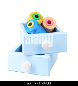 Colorful skeins of thread in wooden boxes isolated on white Stock Photo