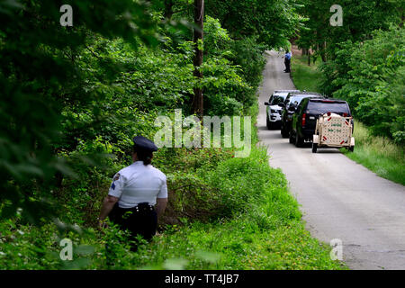 Philadelphia, United States. 13th June, 2019. Police officers and forrest rangers search a wooded area during a five day long chase for a two-year old male black bear after multiple residents reported sightings in Montgomery County and Northwest Philadelphia, PA, on June 13, 2019. While rare inside the city limits it is not unusual in this time of the year as young bears start to migrate after being pushed away by their mothers. Credit: OOgImages/Alamy Live News Stock Photo