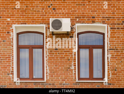 Old brick building with Windows and air conditioning Stock Photo