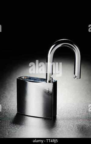 Steel padlock on the black textured background Stock Photo - Alamy