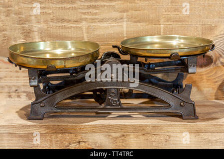 Old antique iron scales on wooden background Stock Photo