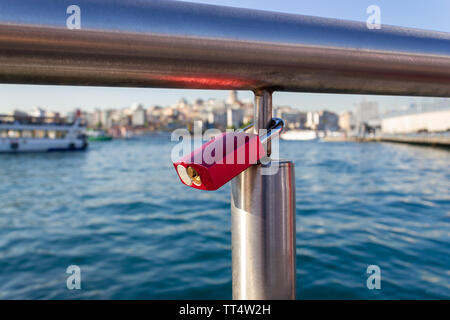Padlock hanged on bridge iron railing Stock Photo