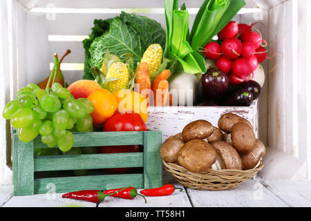 Vegetables in wooden boxes on white wooden box background Stock Photo