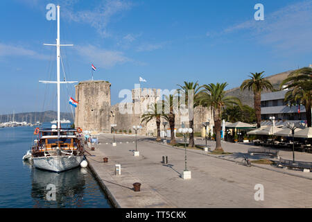 Trogir's quay, backed by the medieval Castle of Kamerlengo and the city walls.  Founded by Greeks in the 3rd century BC, Trogir is immediately north o Stock Photo