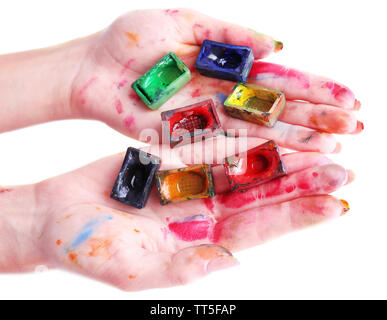Watercolor paint cubes in female hands isolated on white Stock Photo