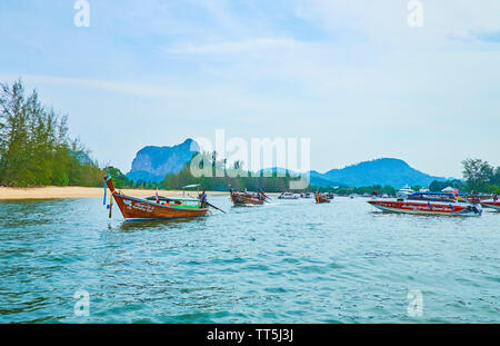 AO NANG, THAILAND - APRIL 27, 2019: The longtail and speed boats float along the Klong Son canal to Andaman sea, on April 27 in Ao Nang Stock Photo