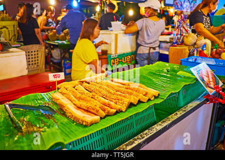 AO NANG, THAILAND - APRIL 27, 2019: The food stall of Night Market with slices of roasted pork belly on the counter, on April 27 in Ao Nang Stock Photo