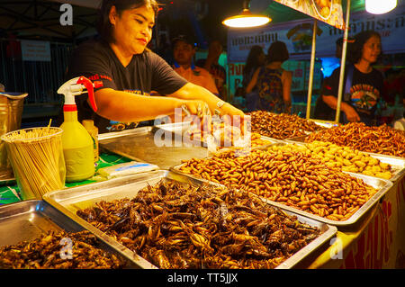 AO NANG, THAILAND - APRIL 27, 2019: The fried insects attract the tourists to the stall of Ao Nang Night Market, on April 27 in Ao Nang Stock Photo