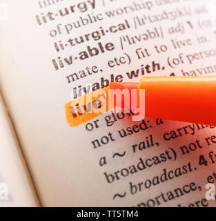 Orange marker highlighting word in dictionary Stock Photo