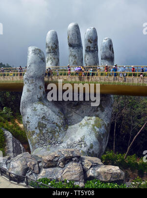 Ba Na, Vietnam - June 06, 2019; The Golden Hand Bridge at Ba Na in the central highlands of Vietnam. Stock Photo