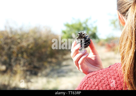 Girl holding cone in hand, outdoors Stock Photo