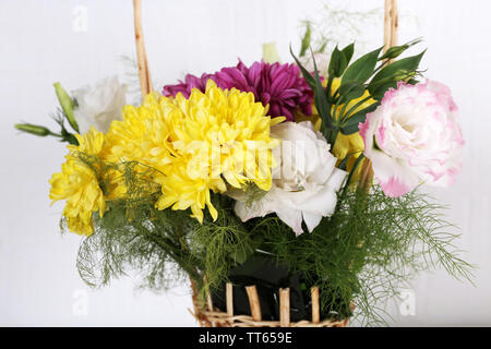 Flowers in basket on white background Stock Photo