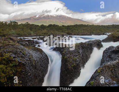Petrohue Falls and Osorno Volcano with its snowy peak near Puerto Varas, Chilean Patagonia, Lake District, Chile, South America. Stock Photo
