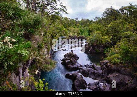 Turquoise waters of the Petrohue River in the Patagonia region of the Andes Mountains in Chile; at its origin are the Petrohue Waterfalls.