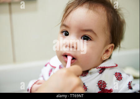 Baby brushing teeth before go sleep. Portrait of little kid with toothbrush Stock Photo